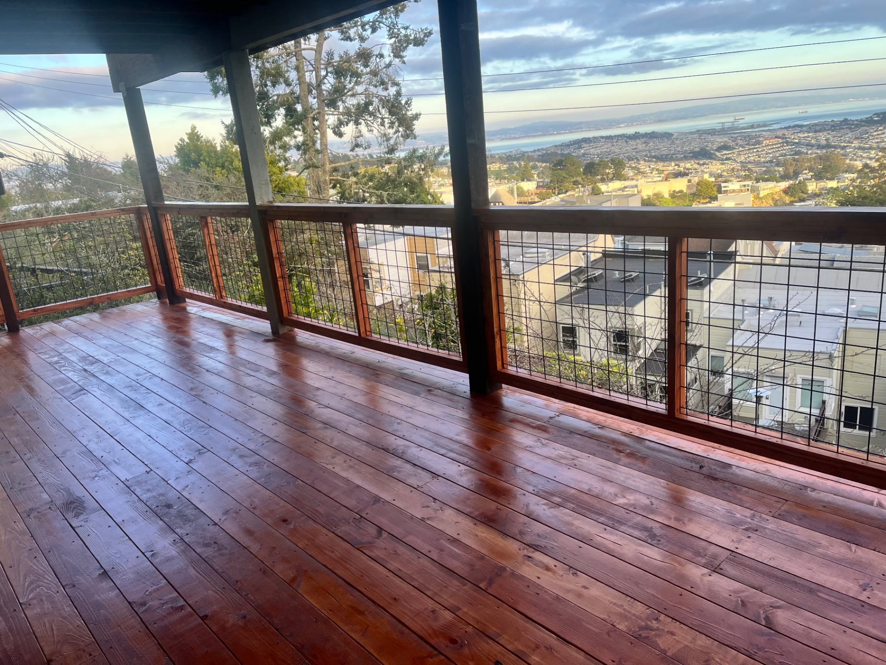 Covered upper level of a redwood deck overlooking San Francisco and the bay